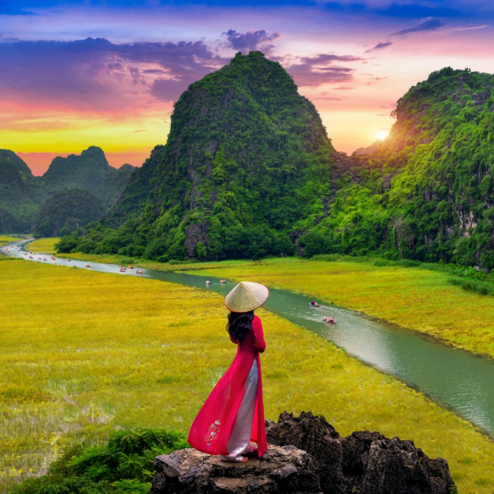 Asian woman wearing Vietnam culture traditional at Tam coc, Vietnam.